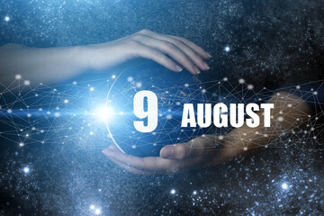 August 9th. Day 9 of month, Calendar date. Human holding in hands earth globe planet with calendar...