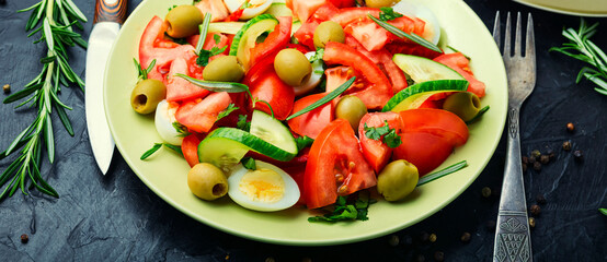 Salad with vegetables, olives, eggs and rosemary