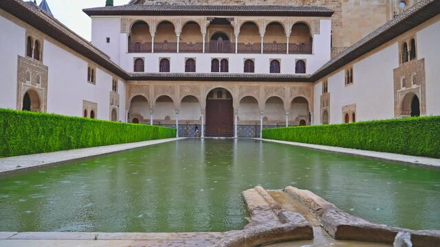 Rain falling at the pool of Courtyard of the Myrtles. Alhambra, Granada, Spain
