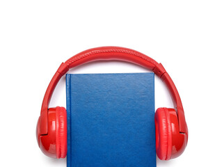 Modern headphones with book on white background