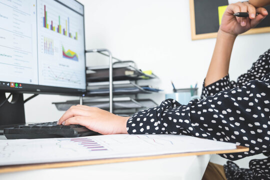 Beautiful young woman in casual clothing using computer and while working indoor.