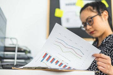 Beautiful young woman in casual clothing using computer and while working indoor.