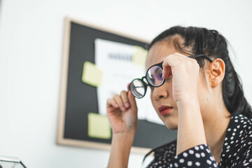 Young woman taking off glasses tired of computer work, exhausted student or employee suffering from...