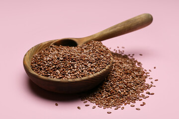 Bowl with flax seeds on color background, closeup