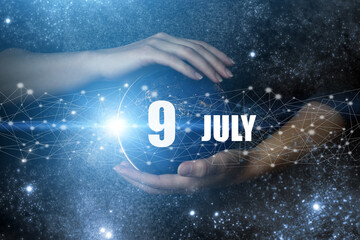 July 9th. Day 9 of month, Calendar date. Human holding in hands earth globe planet with calendar...