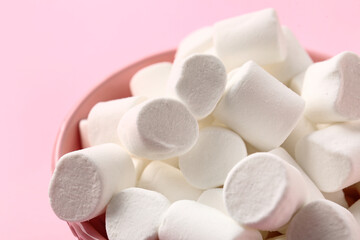 Fototapeta na wymiar Bowl with tasty marshmallows on color background, closeup
