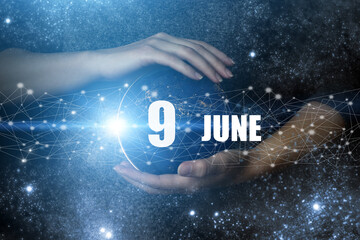June 9th. Day 9 of month, Calendar date. Human holding in hands earth globe planet with calendar...
