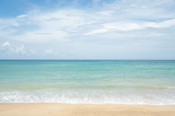 beach with sky and clouds.Landscape waves nature splashes beach sunlight.Blue sea waves and sky on sand beach.