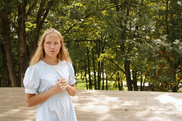 Young beautiful woman thought about it against backdrop of nature