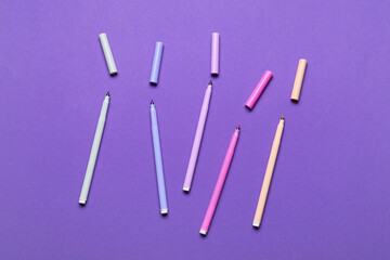 Colorful markers on color background