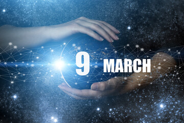 March 9th. Day 9 of month, Calendar date. Human holding in hands earth globe planet with calendar...