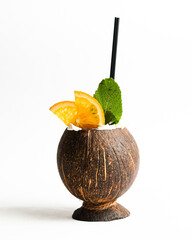 Cocktail made of cracked coconut against white background.