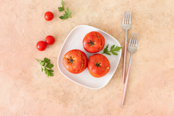 Composition with tasty stuffed tomatoes on color background