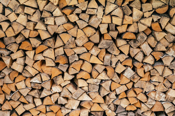 Texture background image of chopped firewood stacked in a woodpile, copy space
