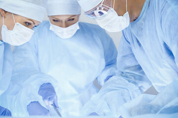 A group of surgeons is operating at the hospital. Health care concept