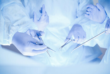 A group of surgeons is operating at the hospital, close-up of hands. Health care concept