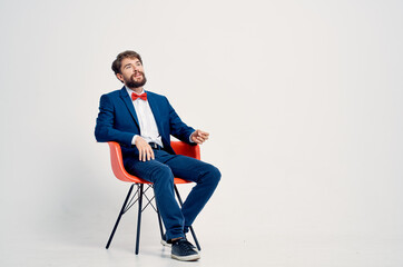Fototapeta na wymiar business man in a suit sitting on a chair studio modern style