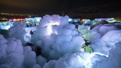Lockdown Time Lapse Shot Of People Exploring Illuminated Ice Castles During Vacation - Midway, Utah