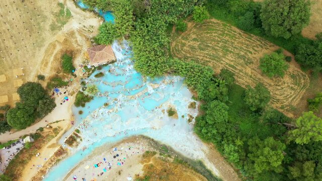 Aerial top view of natural bath in tuscany, Italy. Hot cristalline water of spa. Saturnia natural spa with waterfalls hot springs at Saturnia thermal baths, Grosseto,Tuscany. Beautiful panoramic shot.