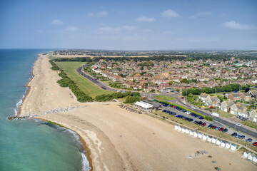 Goring by Sea beach with the popular Cafe with the greensward in view behind the beach at this...