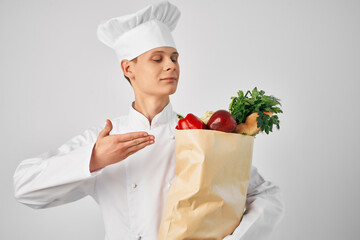 a man in a chef's uniform with a package of groceries delivery of a restaurant service