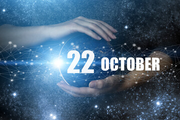 October 22nd. Day 22 of month, Calendar date. Human holding in hands earth globe planet with calendar day. Elements of this image furnished by NASA. Autumn month, day of the year concept.