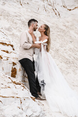 Beautiful wedding couple bride and groom at wedding day outdoors at ocean beach. Happy marriage couple o