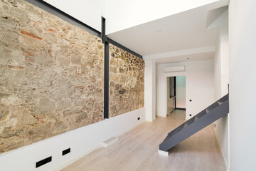Mix of new and old architecture. Refurbished apartment with restored ancient wall left from old...