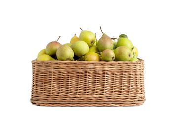 Ripe green and red-sided pears in a wicker basket on a white background, close-up. Juicy and healthy fruit