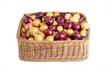 Multicolored yellow and red onions in a wicker basket on a white background, isolate, vegetable