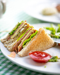 beef sandwich with salad dressing on the table