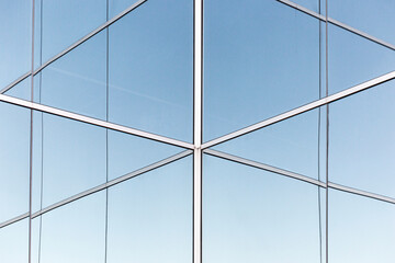 Geometric glass wall of contemporary building.