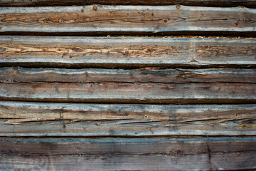 Old rustic aged wooden barn wall. Vertical planks, close up, front view, detail shot