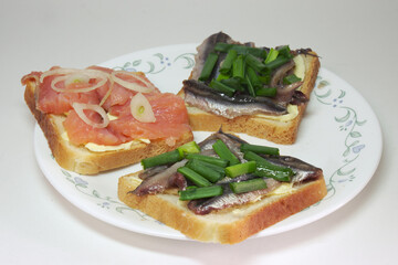 sandwiches with solted europian sprat and slices of salted salmon on butter, seasoned with chopped shallots