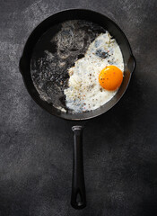 Fried chicken egg in a cast iron pan