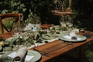 table set up with a wooden table, lemons, and greenery for a Mediterranean rustic outdoors wedding