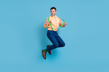 Fototapeta na wymiar Photo of crazy funny dream guy jump have fun wear suspenders shirt bow tie isolated blue color background