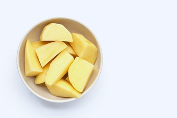 Fototapeta na wymiar Fresh potato cut into pieces in bowl on white background.