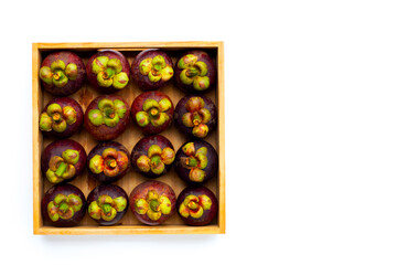 Mangosteen in wooden box on white background.