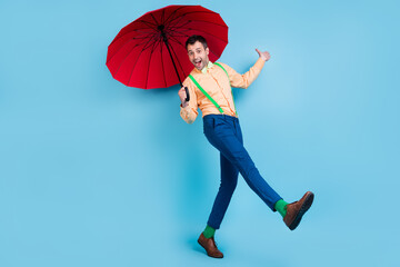 Full body photo of go brunet man with parasol wear shirt trousers socks shoes isolated on blue color background
