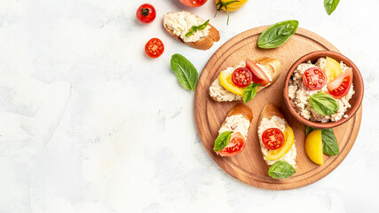 Tasty sandwich with tomatoes, cream cheese and basil leaves on white background. Long banner format. top view