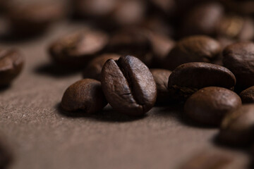 Coffee beans close-up. Macro photography of coffee on a brown background. A place for text in food photos. Arabica.