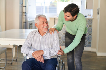 Mann vom Pflegedienst oder Sohn hilft Senior im Rollstuhl