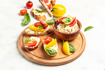 Tapas, antipasti with chopped vegetables, tomatoes, cream cheese and basil leaves. on grilled baguette bread. Clean eating, dieting, vegan food concept. top view