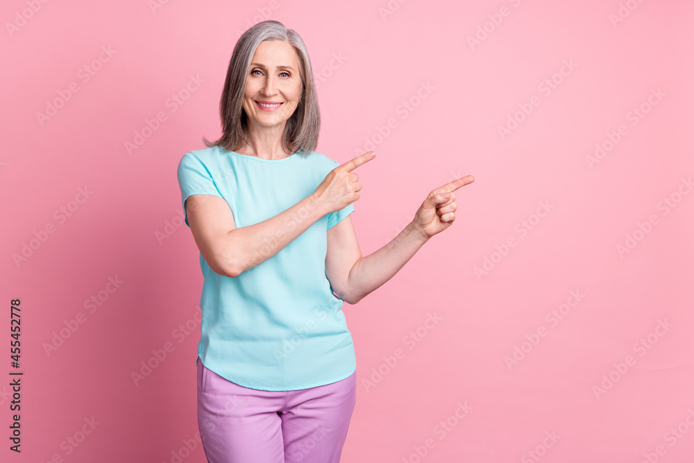 Sticker Photo of lovely elder grey hairdo lady point empty space wear teal blouse isolated on pink color background