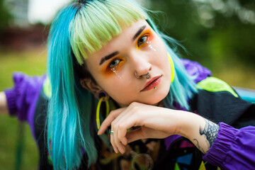 Back in time 90s 80s. Stylish girl in retro jacket. Closeup fashion portrait young pretty beautiful girl with green and blue hair. Beautiful fashion girl with luxury professional makeup.