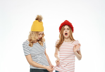 two trendy women in striped t-shirts multicolored hats modern style