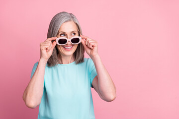 Photo of funky aged white hair lady look empty space wear spectacles teal blouse isolated on pink color background