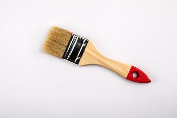 Clean paint brush with a wooden handle on a white background