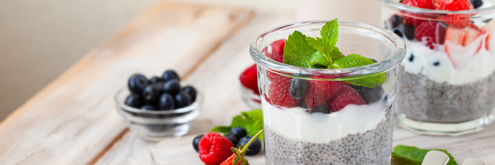 Vegan low calories chia seed pudding with fresh organic berries, plant milk, mint. Concept of dieting, detox, tasty simple super food, healthy sweet desserts. Banner. Wooden background - Powered by Adobe